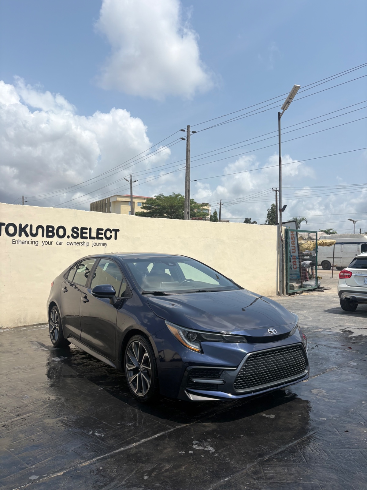Front three-quarter Lagos photo after bodywork, reassembly, paint finishing, and detailing with the Corolla back together.