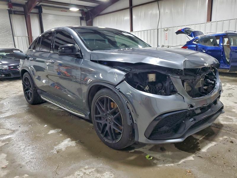Front three-quarter auction photo showing the heavy nose damage, missing grille area, and exposed front cooling components.
